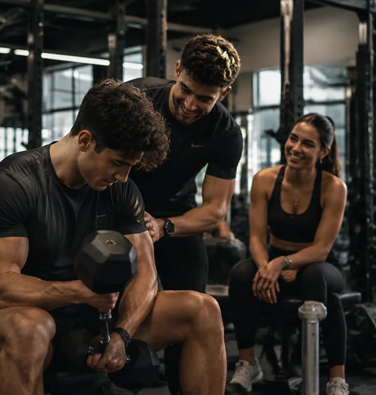 Young adults encouraging one another in the gym